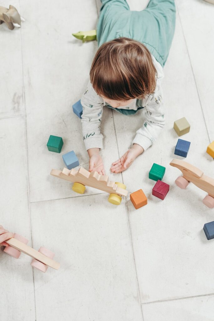 montessori toys for 1 year old, Baby playing with coloured blocks