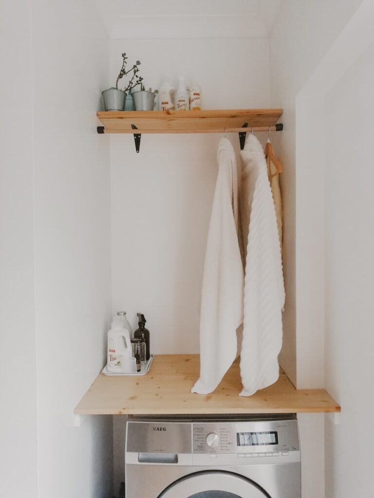 white bath towel on brown wooden table, best eco friendly laundry detergent