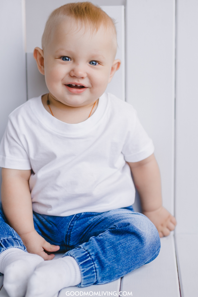 baby boy sitting wearing jeans