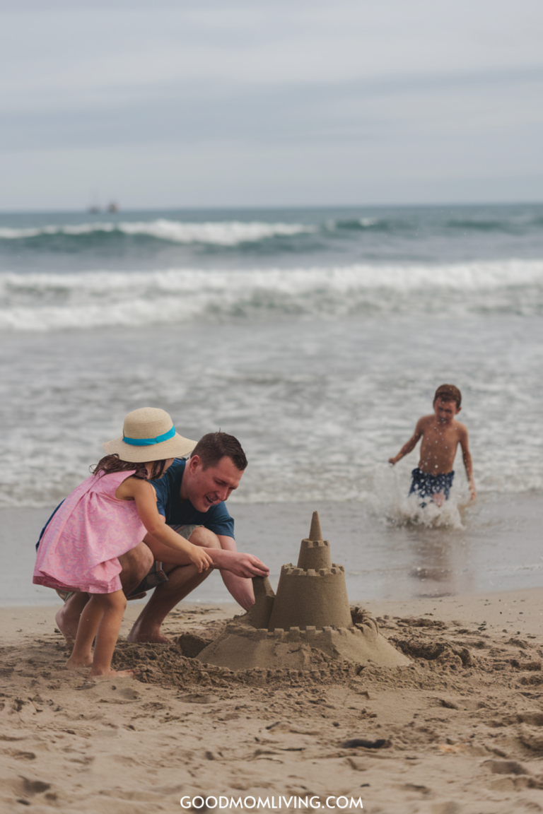Father and daughter building a sandcastle on the beach, with a young boy playing in the waves in the background. The scene captures a joyful family day at the seaside, showcasing creativity and fun in the sand.