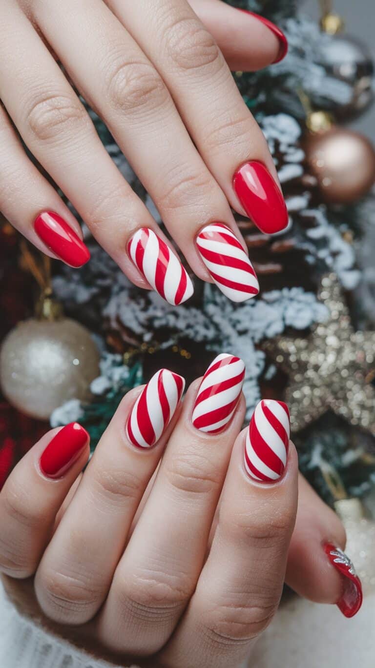 Hands with festively painted nails featuring a red and white candy cane stripe pattern against a holiday-themed background with ornaments.