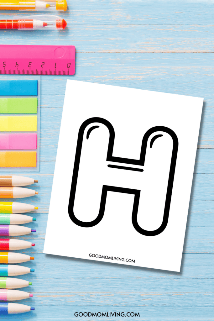 Coloring page featuring a large bubble letter 'H' on white paper, surrounded by colorful pens, a pink ruler, and sticky notes on a light blue wooden background.