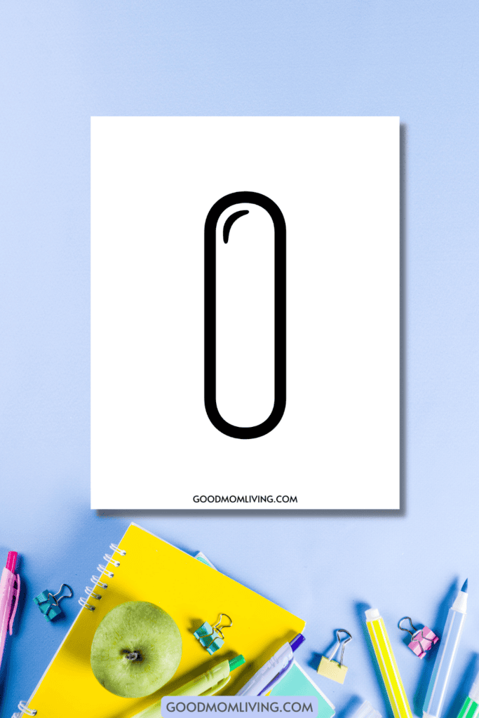 A sheet of paper with a large uppercase letter 'I' printed on it is placed on a blue surface next to colorful stationery items, including a green apple, notebooks, pens, and binder clips. The website goodmomliving.com is printed at the bottom of the paper.