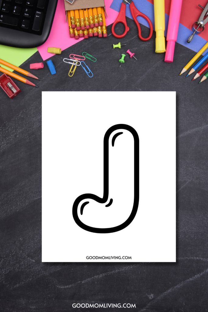 A stylized letter 'J' in black outline on a white sheet of paper, surrounded by school supplies like pencils, paperclips, erasers, and scissors on a dark chalkboard background.
