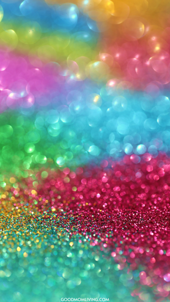 A vibrant, colorful bokeh background featuring a spectrum of colors including blue, green, yellow, pink, and red, with a glittery, sparkling effect in the foreground.