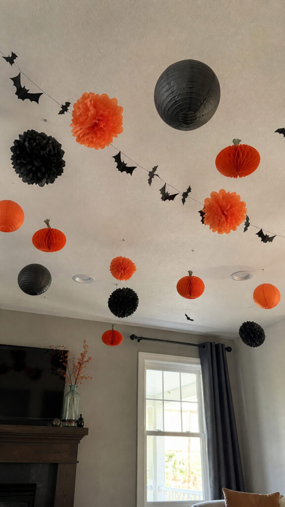 Hang Black and Orange Paper Decorations from the Ceiling